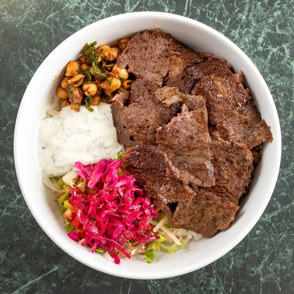 Istanbul Kitchen's Mediterranean doner kebab bowl with meat, chickpeas, yogurt sauce, and pickled cabbage.